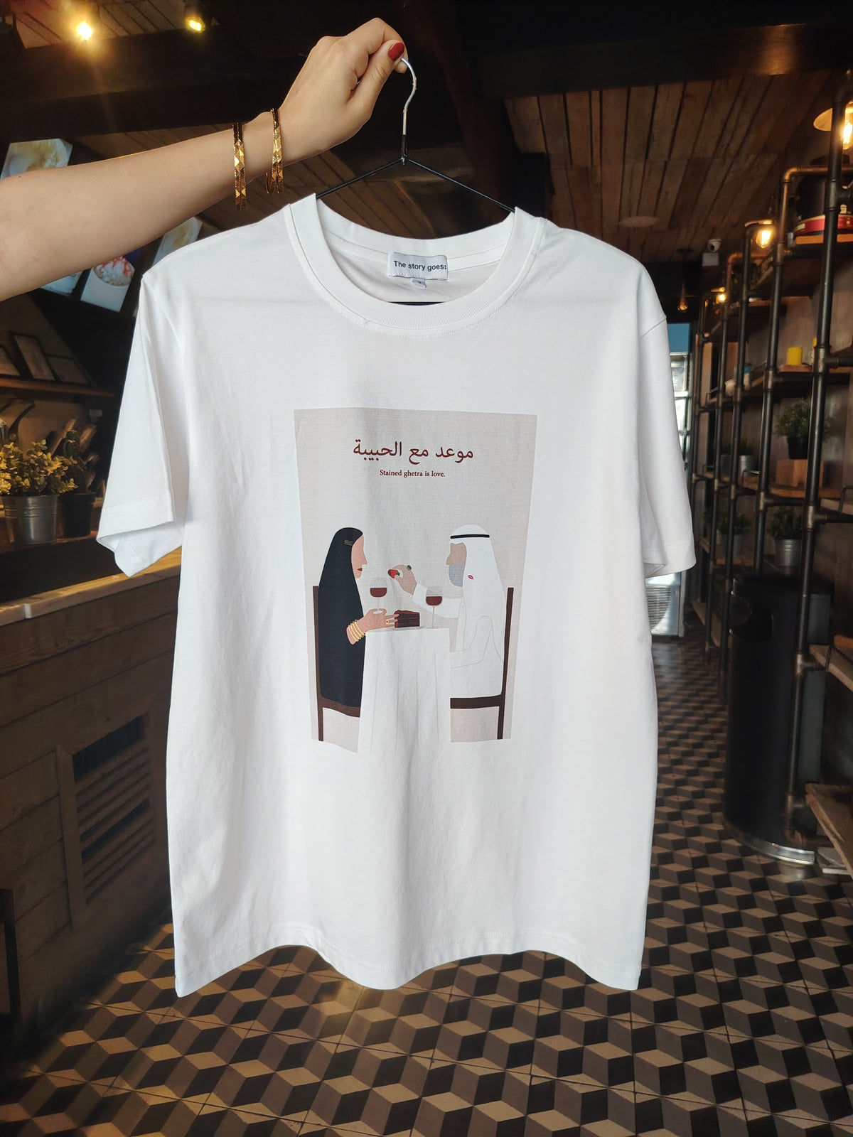 tshirt with custom design of Arab couple out on a date night with chocolate cake on the table and the man feeding the lady chocolate dipped strawberry.